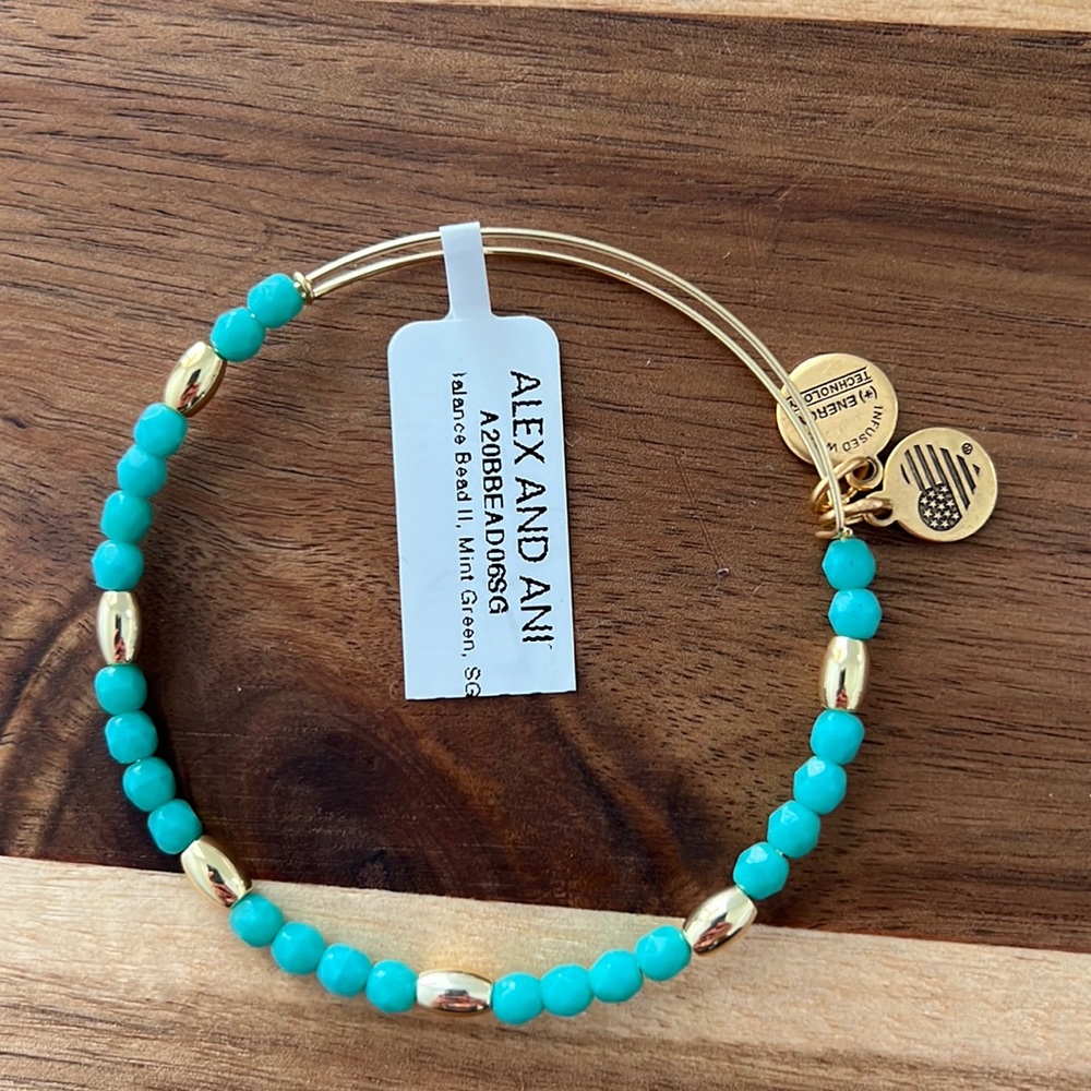 Alex and Ani beaded bracelet in green and shiny gold beads.
